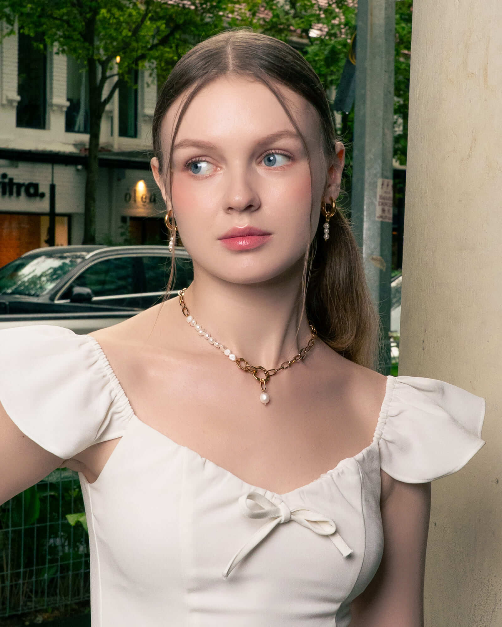 Pebble Pearl Charm Gold Huggie Earrings by LAVANA, on model; classic domed huggies with three freshwater pearl charms