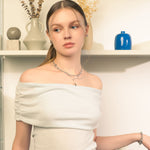 Petite Bow Silver Stud Earrings by LAVANA, on model tiny polished classic ribbon bow design