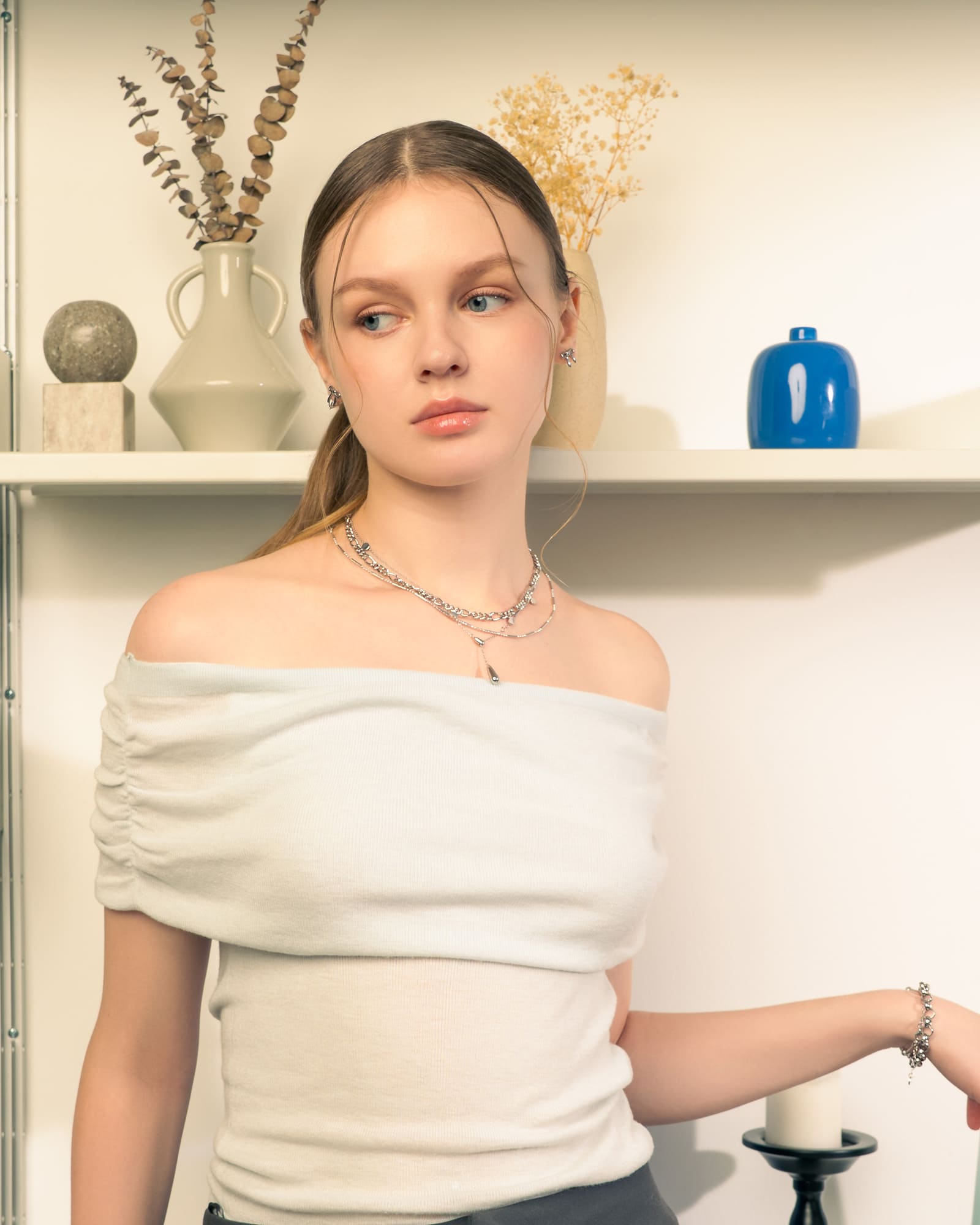 Petite Bow Silver Stud Earrings by LAVANA, on model tiny polished classic ribbon bow design