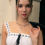 Pisces Silver Zodiac Tag Necklace by Lavana, on model; engraved tag on classic beaded chain 