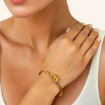 Pretzel Knot Gold Cuff Bracelet by Lavana on model with polished centre knot on an open cuff
