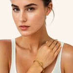 Pretzel Knot Gold Cuff Bracelet by Lavana on model with polished centre knot on an open cuff