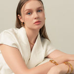 Pretzel Knot Gold Hoop Earrings by LAVANA, on model trendy Slim hoop with front twist and lever latch