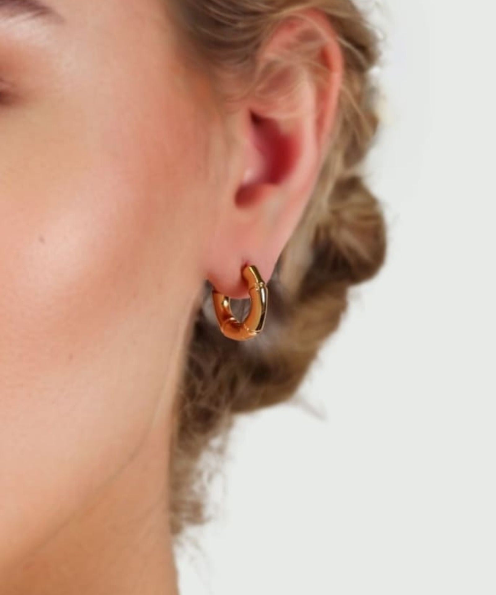 Prosperity Bamboo Gold Huggie Earrings by LAVANA on model bamboo textured ridges with a compact thick profile