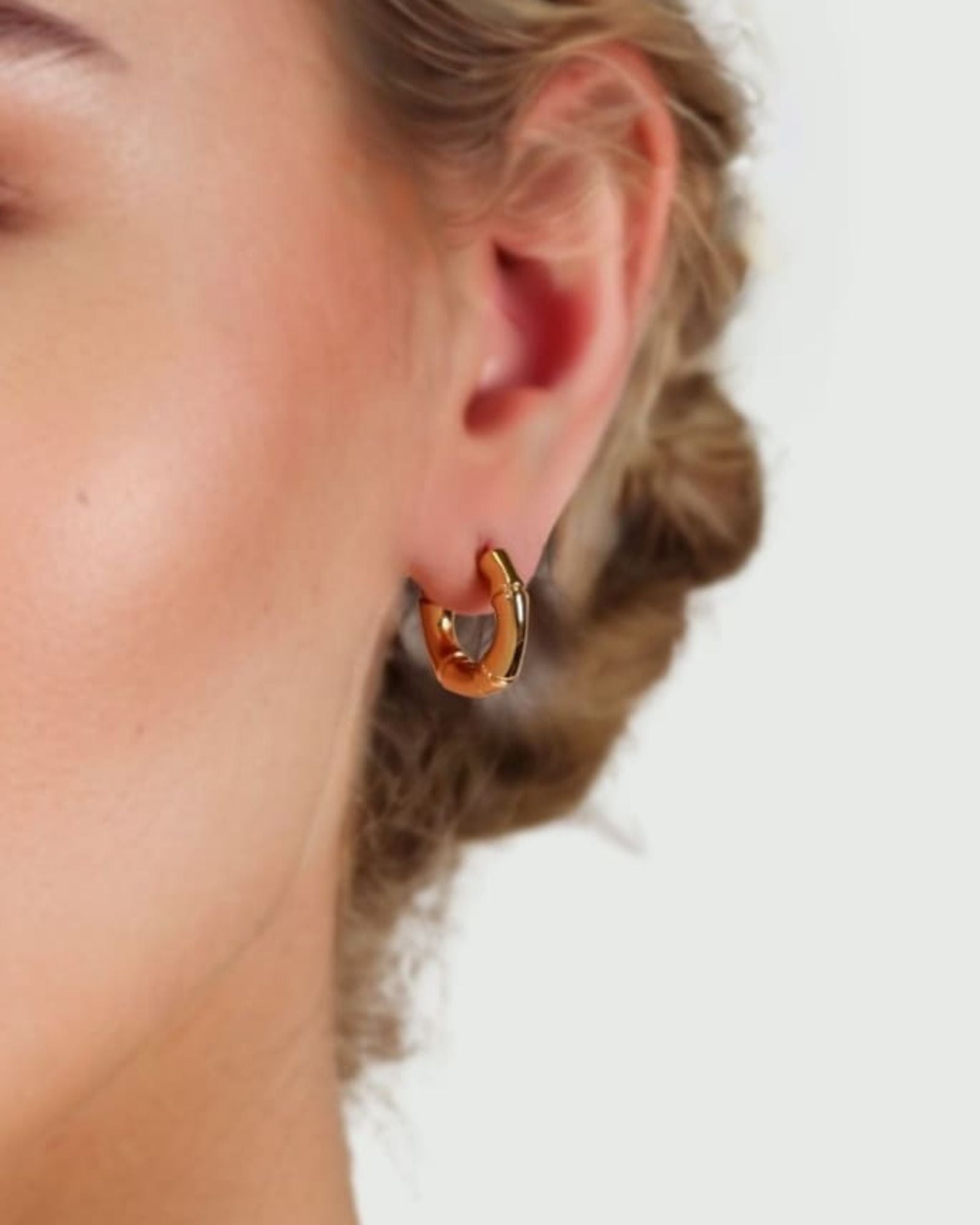 Prosperity Bamboo Gold Huggie Earrings by LAVANA on model bamboo textured ridges with a compact thick profile