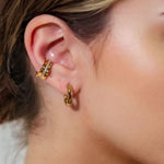 Prosperity Bamboo Gold Huggie Earrings by LAVANA on model bamboo textured ridges with a compact thick profile