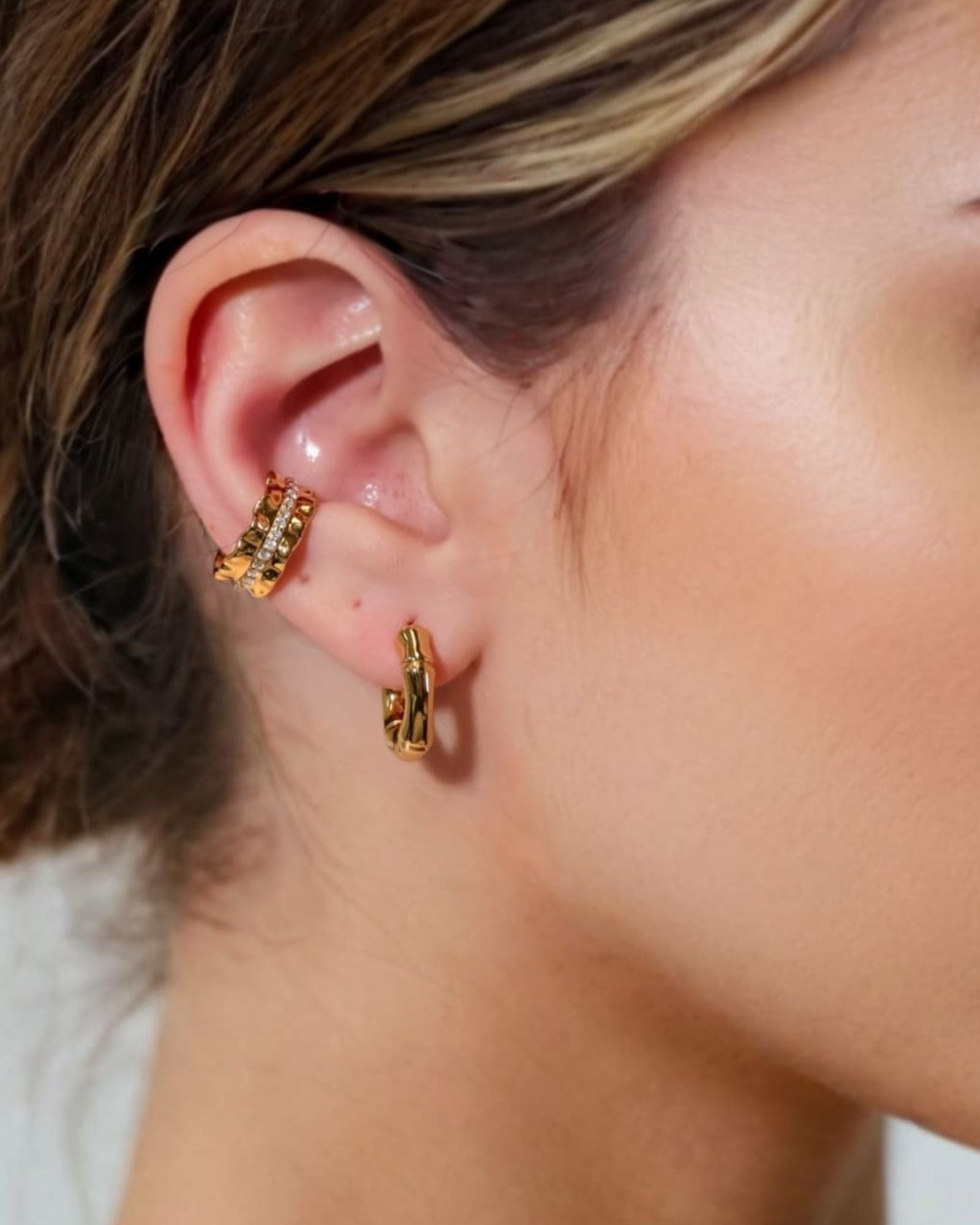 Prosperity Bamboo Gold Huggie Earrings by LAVANA on model bamboo textured ridges with a compact thick profile