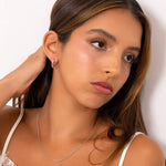 Prosperity Bamboo Gold Huggie Earrings by Lavana on model bamboo textured ridges with a compact thick profile