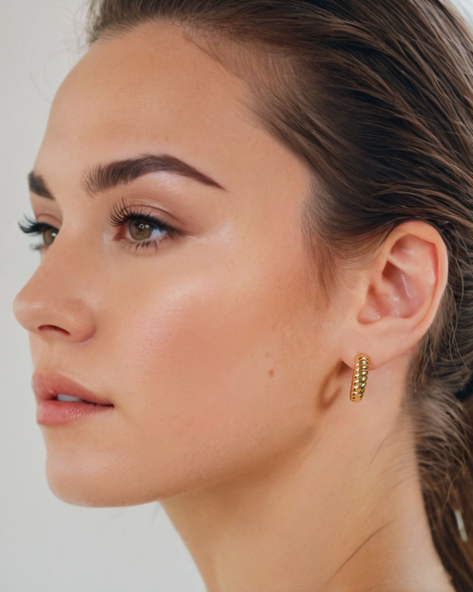 Puffy Croissant Gold Hoop Earrings by Lavana on model polished domed open hoop with croissant shape