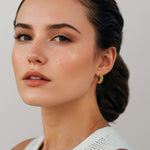 Puffy Croissant Gold Hoop Earrings by Lavana on model polished domed open hoop with croissant shape