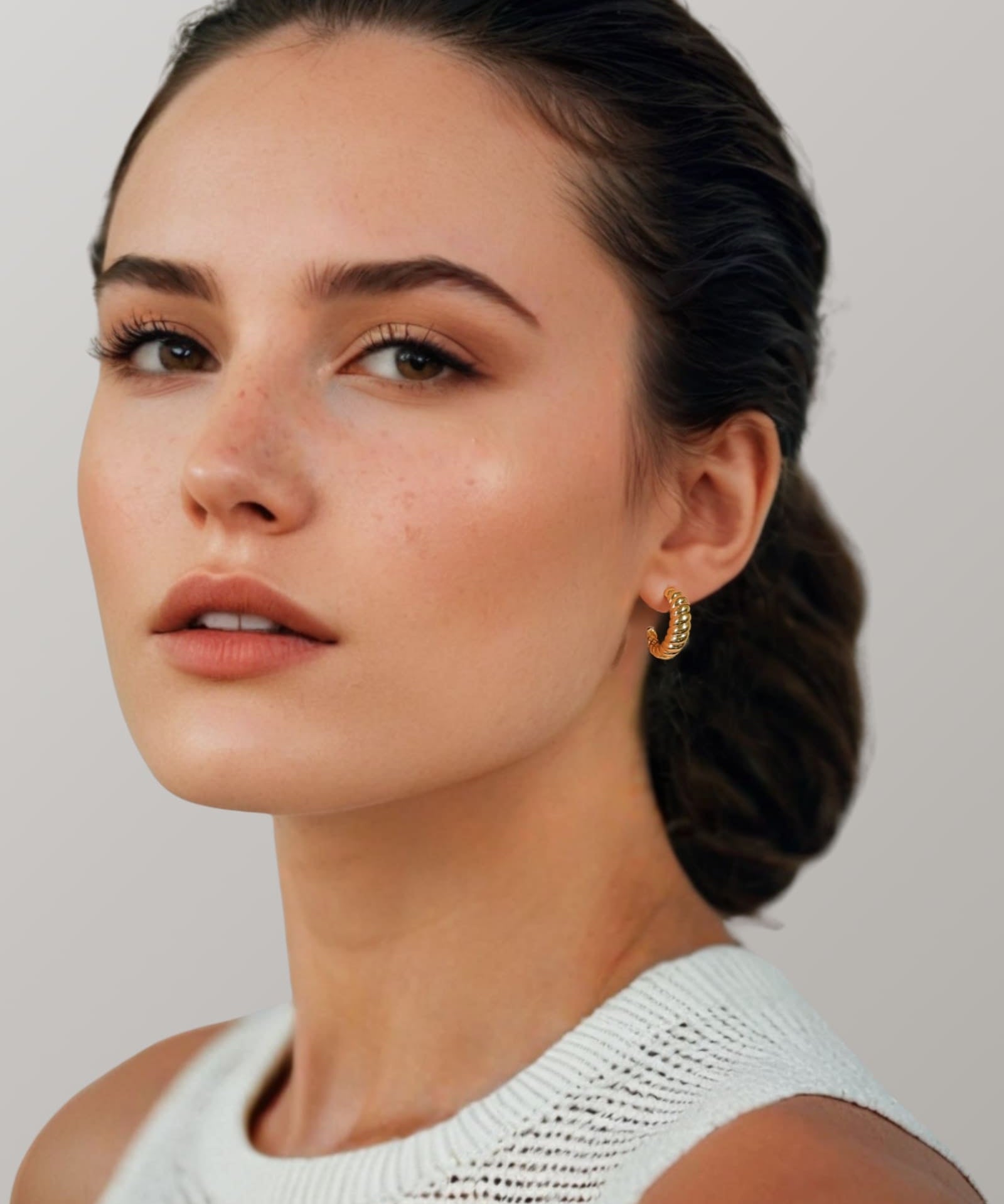 Puffy Croissant Gold Hoop Earrings by Lavana on model polished domed open hoop with croissant shape