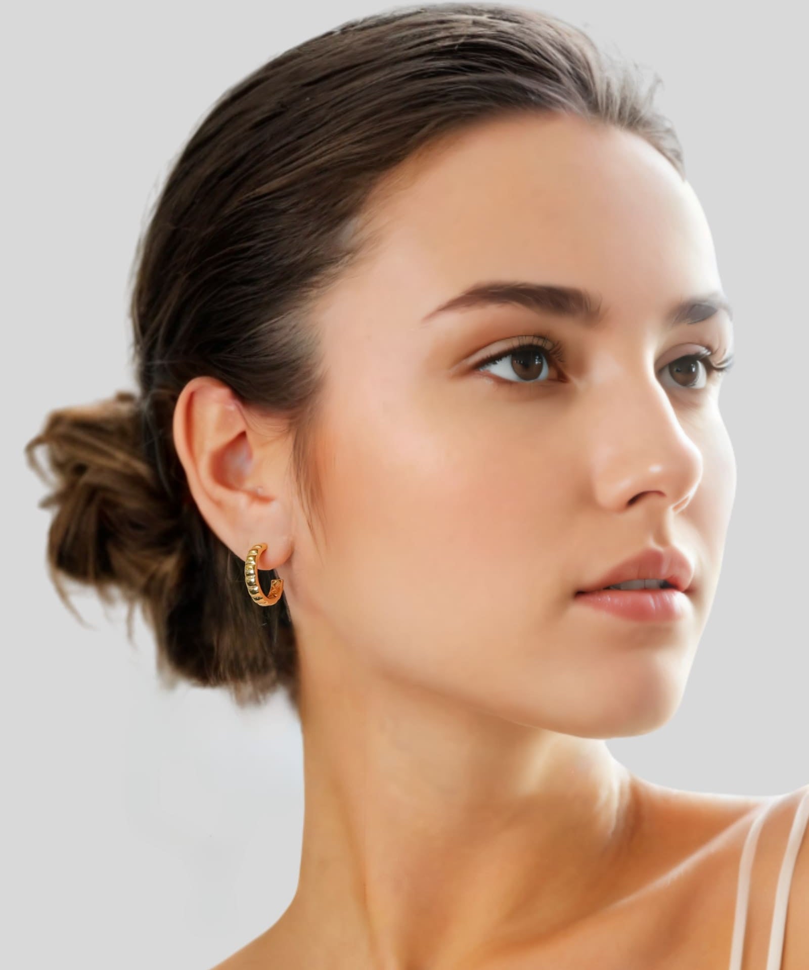 Puffy Cubic Gold Hoop Earrings by Lavana on model with bold squared dome profile