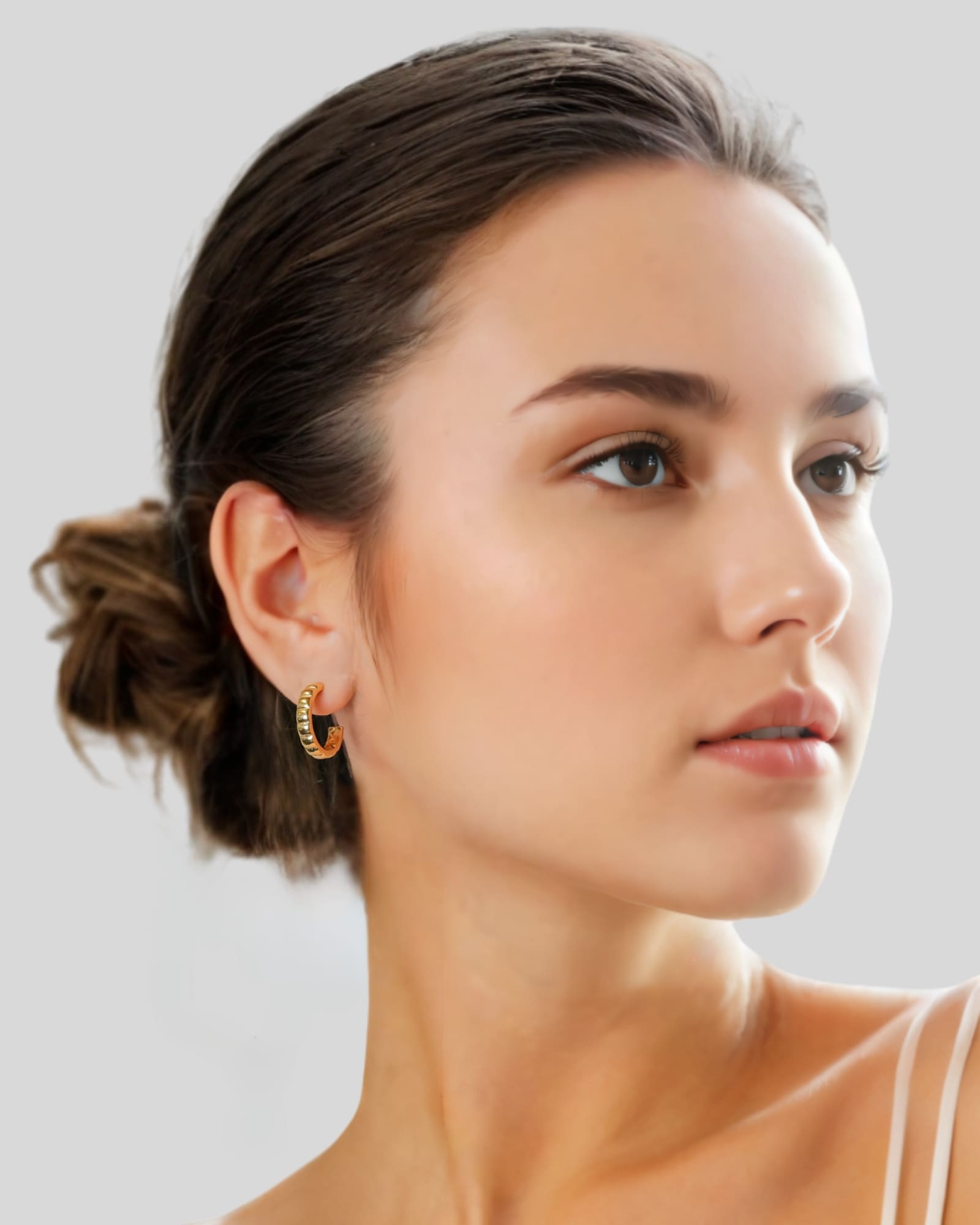 Puffy Cubic Gold Hoop Earrings by Lavana on model with bold squared dome profile