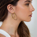 Radiance Gold Hoop Earrings by Lavana on model — lightweight large twisted textured round hoops