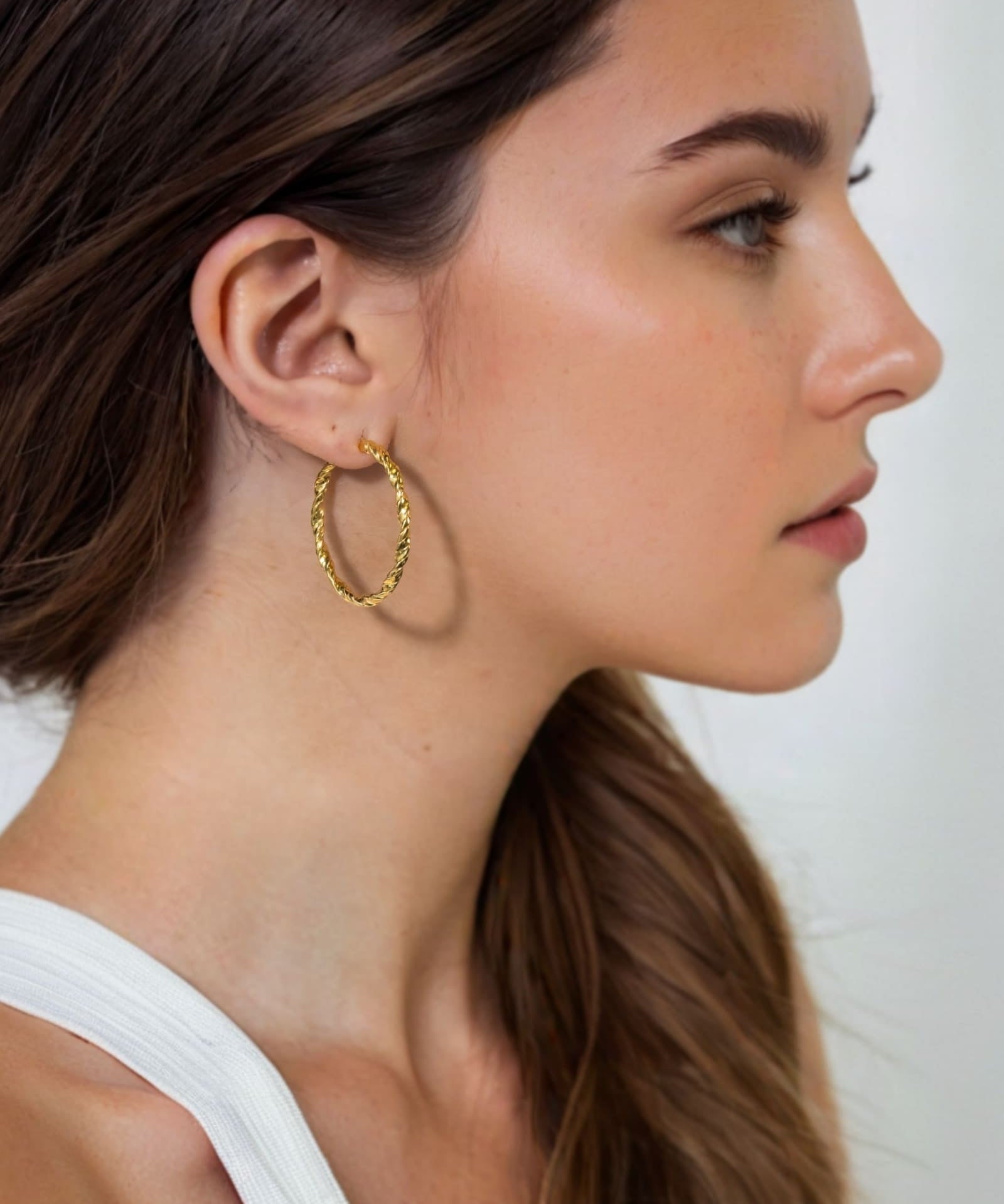Radiance Gold Hoop Earrings by Lavana on model — lightweight large twisted textured round hoops