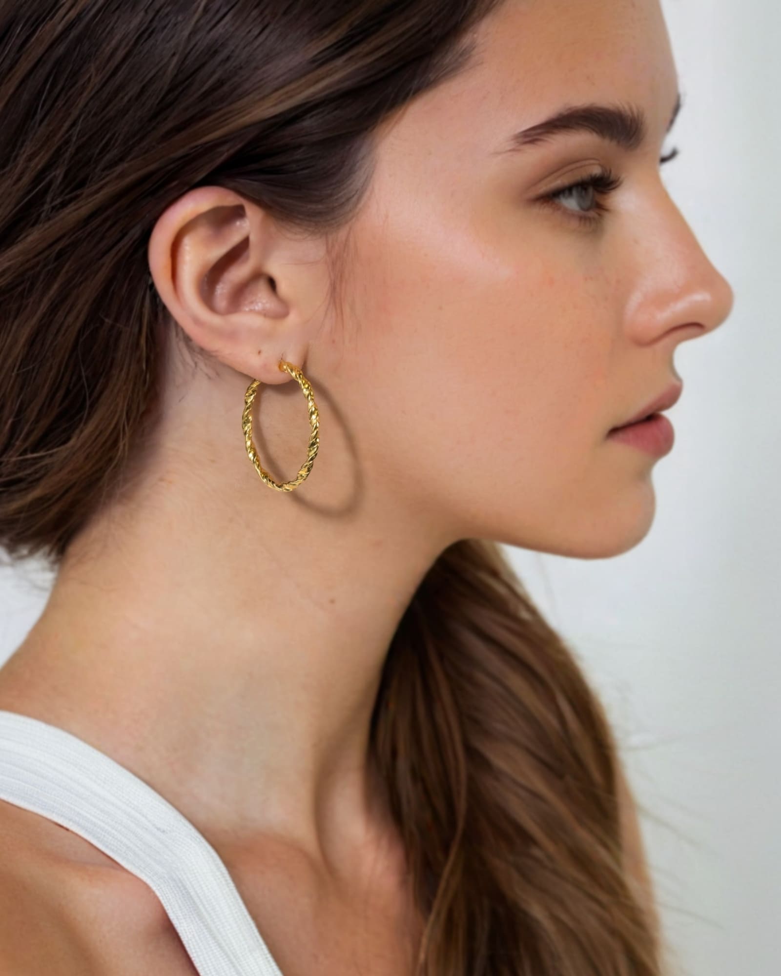 Radiance Gold Hoop Earrings by Lavana on model — lightweight large twisted textured round hoops
