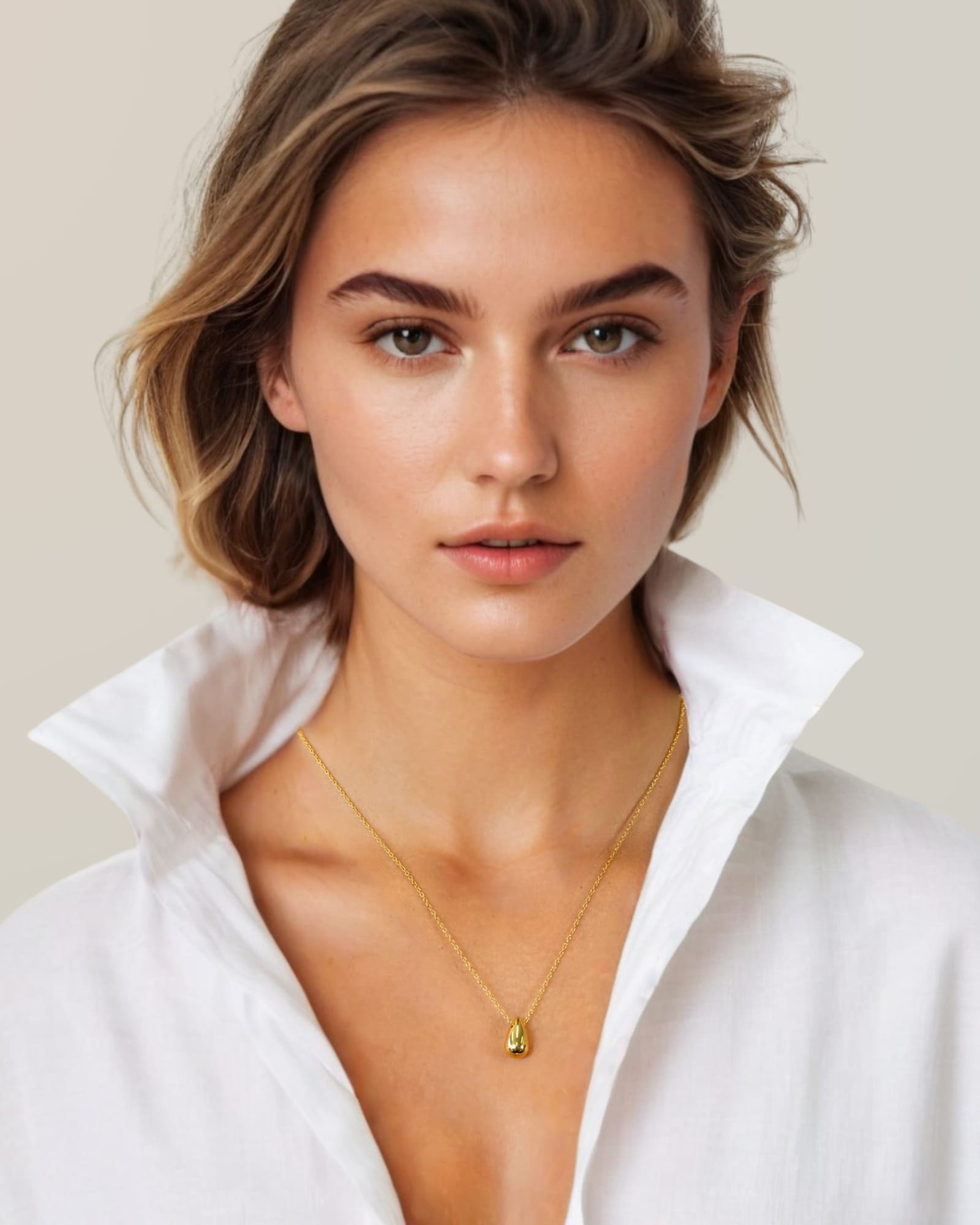 Raindrop Gold Pendant Necklace by Lavana, on model; polished droplet pendant on fine chain