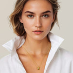 Raindrop Gold Pendant Necklace by Lavana, on model; polished droplet pendant on fine chain