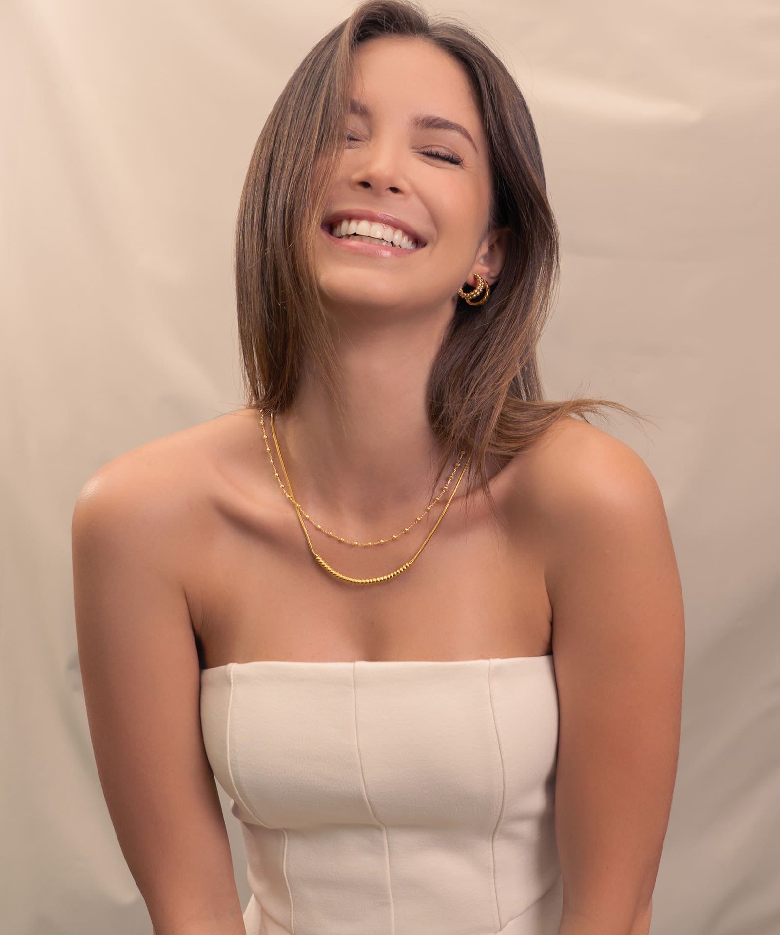 Raleigh Gold Station Chain Necklace by Lavana, on model; fuller bead stations along a classic fine chain