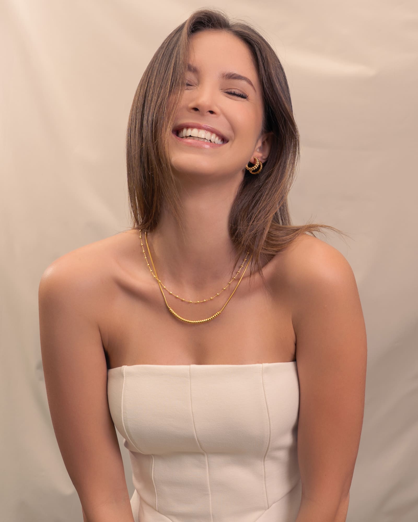 Raleigh Gold Station Chain Necklace by Lavana, on model; fuller bead stations along a classic fine chain