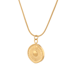 Ray of Sun Gold Pendant Necklace by Lavana, engraved sunburst coin, angled view