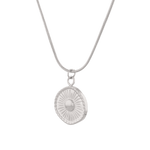 Ray of Sun Silver Pendant Necklace by Lavana, engraved sunburst coin, angled view