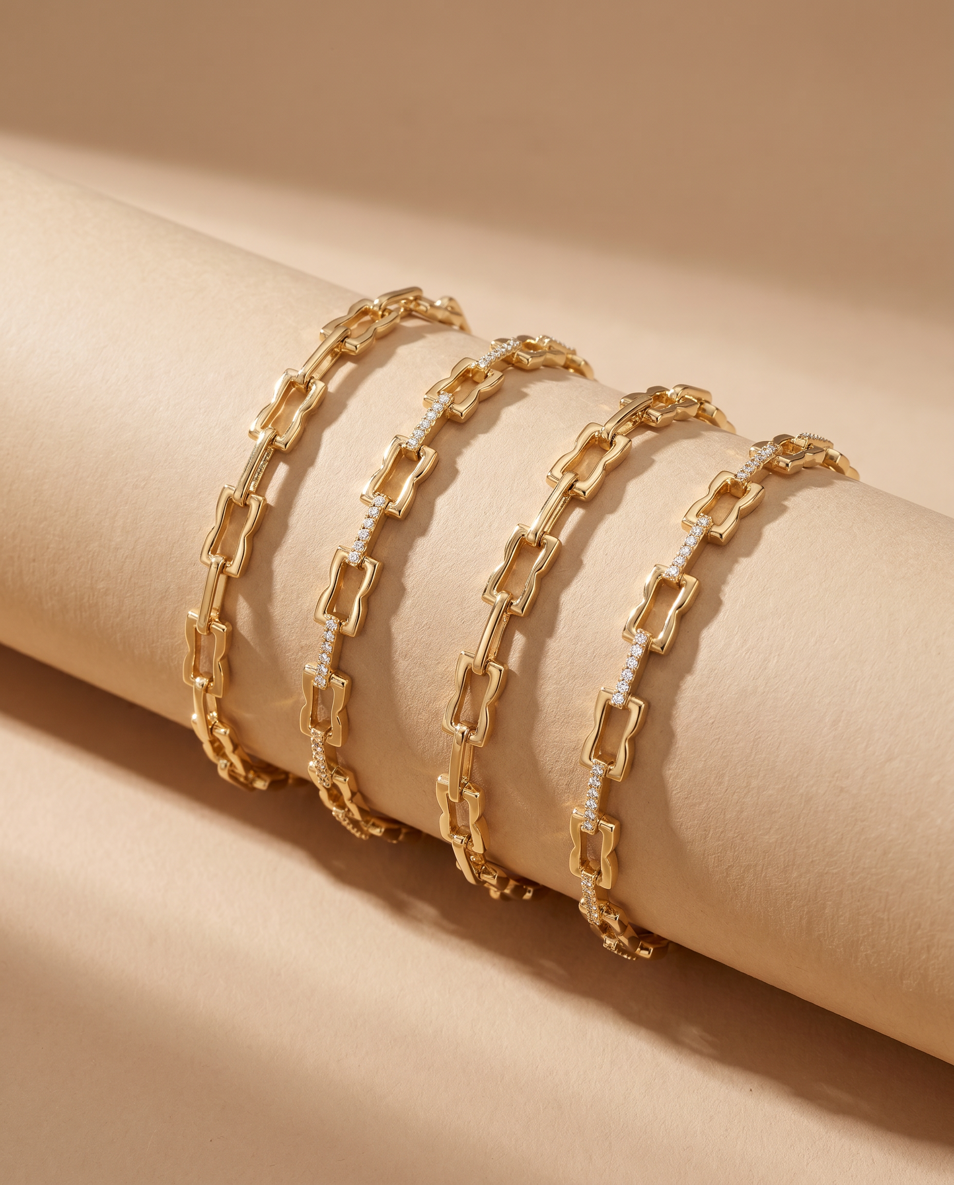 Close-up of LAVANA Signature Gold Bracelet, & Gold Diamond Bangle, layered on a curved beige pedestal.