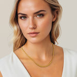 Reflection Gold Chain Necklace by Lavana, on model; polished curved bar on fine chain