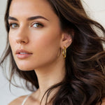 Rhythm Gold Hoop Earrings Large by Lavana on model wide polished hoop with light textured grooves