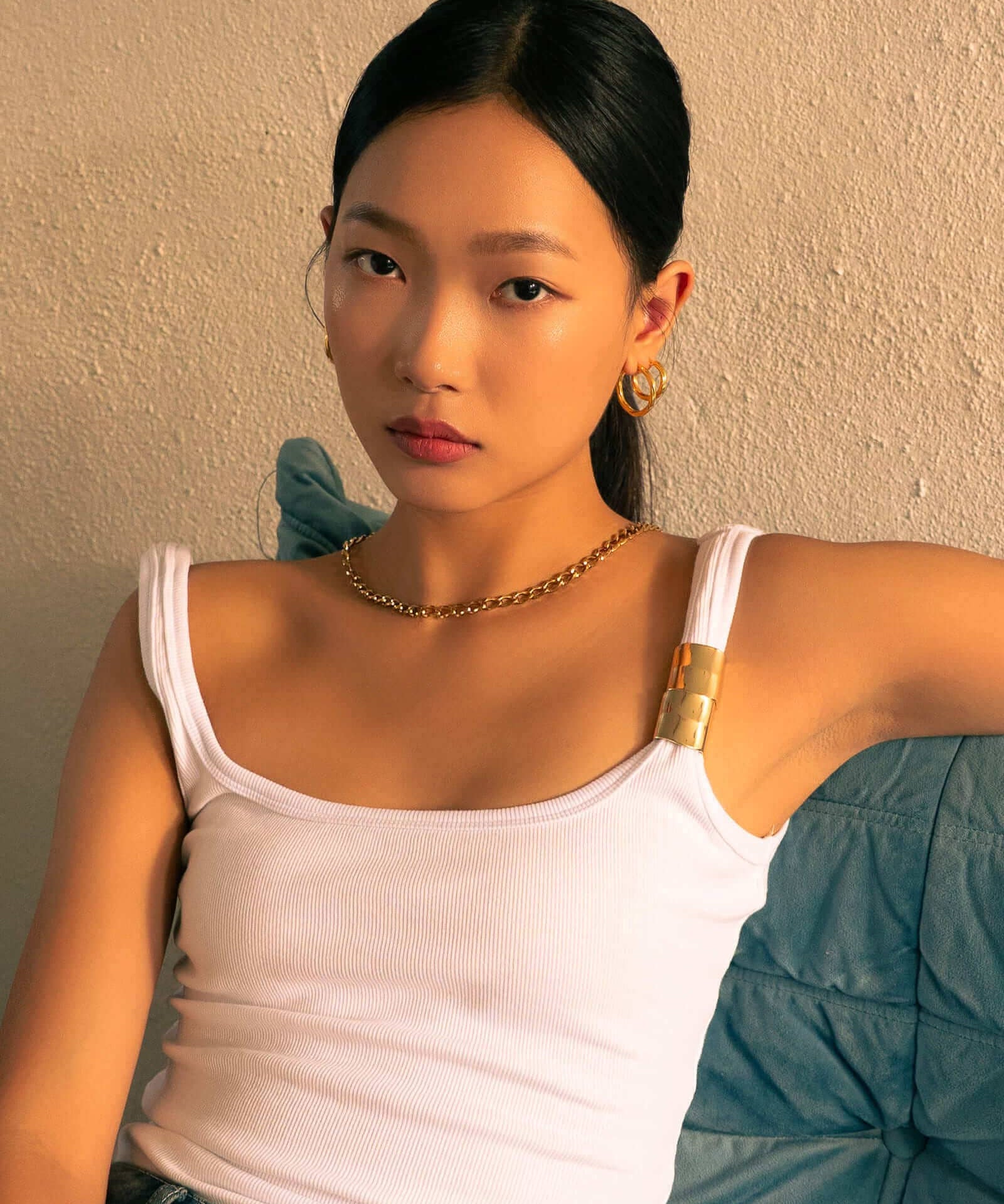 Rhythm Gold L Hoop Earrings by LAVANA, on model; wide polished dress hoops with light textured grooves