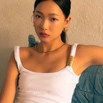 Rhythm Gold L Hoop Earrings by LAVANA, on model; wide polished dress hoops with light textured grooves