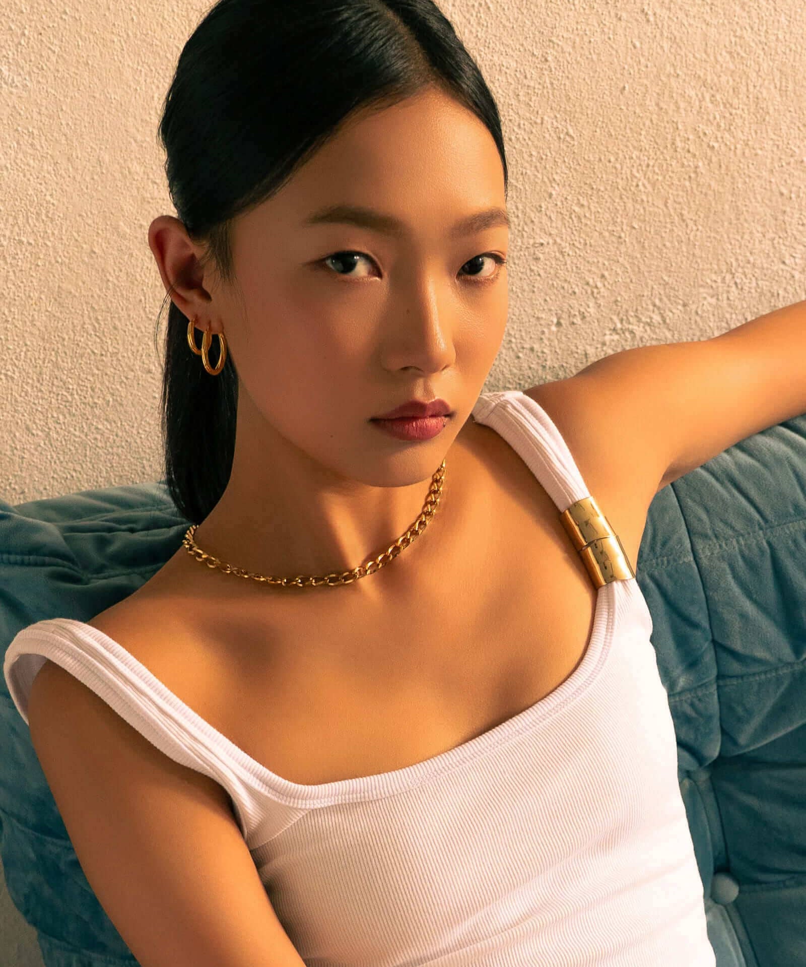 Rhythm Gold M Hoop Earrings by LAVANA, on model; wide polished dress hoops with light textured grooves