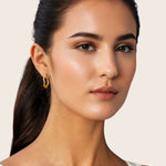 Ripples Gold Hoop Earrings by Lavana, on model; slim round hoops with organic textured ripples