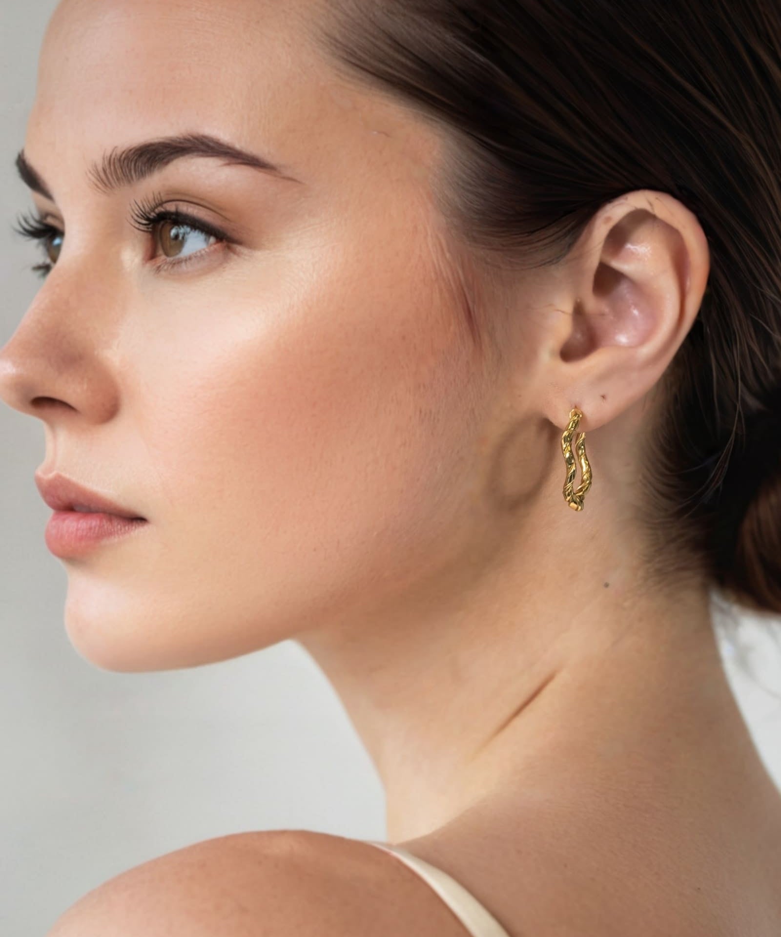 Ripples Gold Hoop Earrings by Lavana on model slim round hoops with organic textured ripples