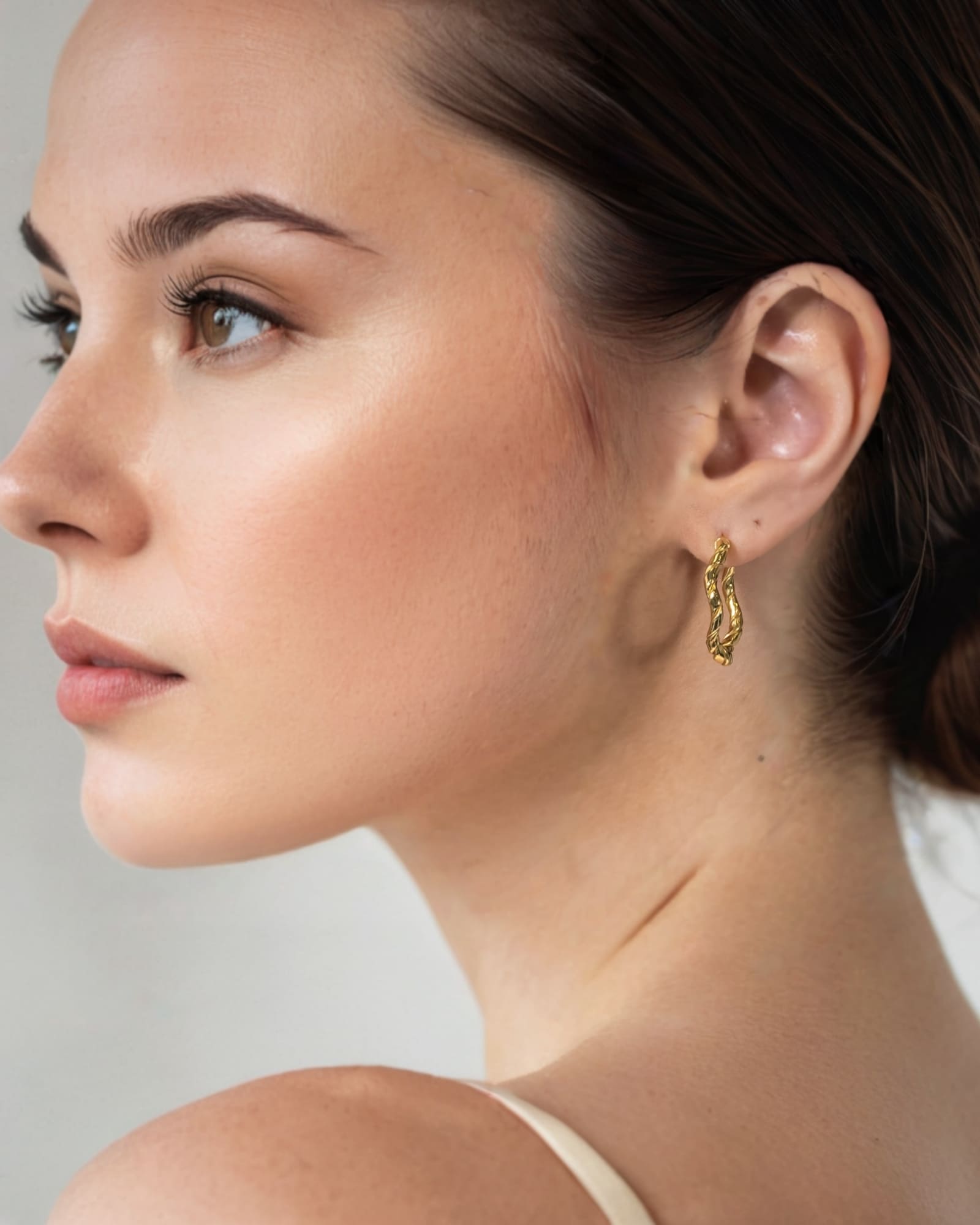 Ripples Gold Hoop Earrings by Lavana on model slim round hoops with organic textured ripples