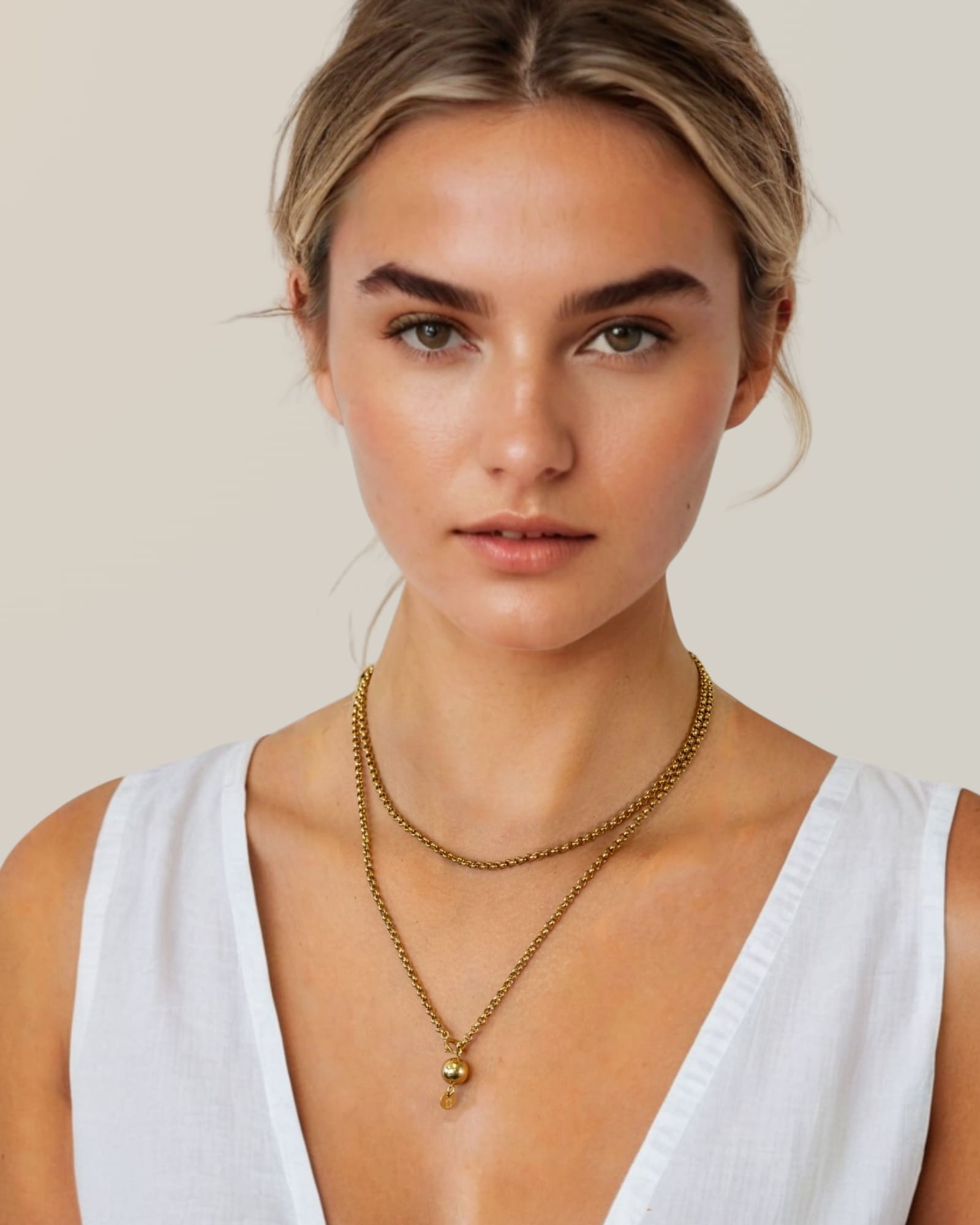 Rolo gold lariat chain necklace by Lavana, on model; wrap and thread design with ball pendant