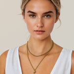 Rolo gold lariat chain necklace by Lavana, on model; wrap and thread design with ball pendant