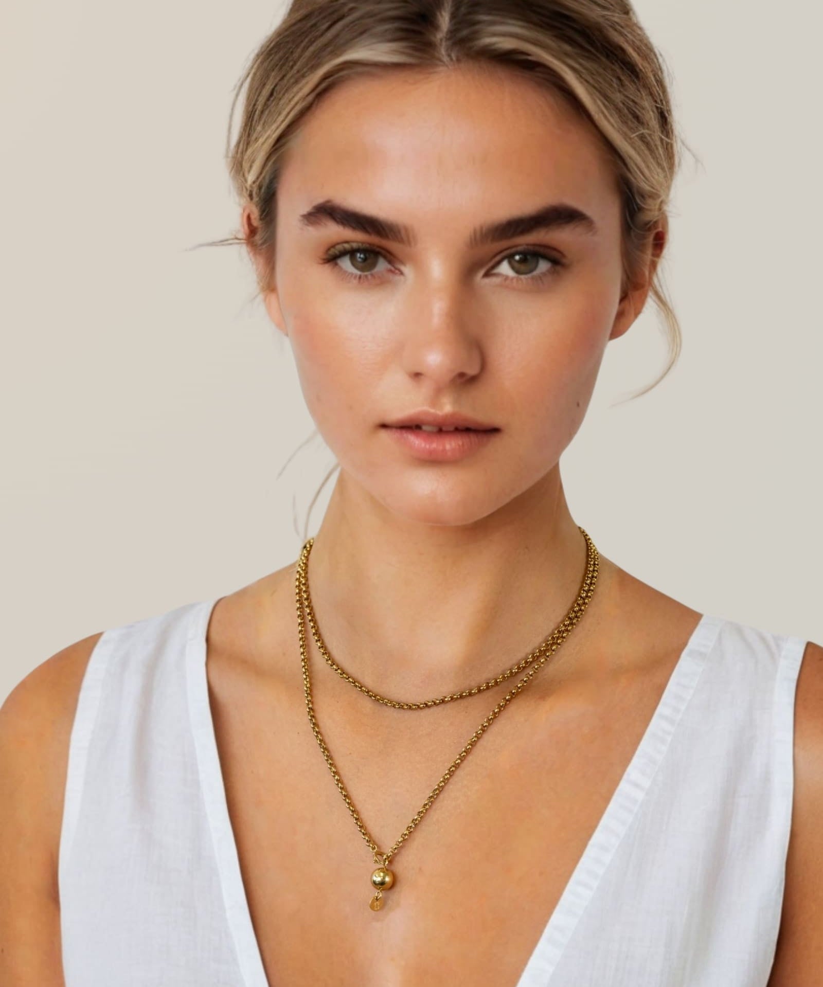 Rolo gold lariat chain necklace by Lavana, on model; wrap and thread design with ball pendant