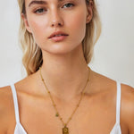Sagittarius Gold Zodiac Tag Necklace by Lavana, on model; engraved tag on beaded chain, back