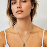 Sagittarius Gold Zodiac Tag Necklace by Lavana, on model; engraved tag on beaded chain, front