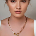 Sardinia Gold Pearl Necklace by Lavana on model with asymmetric links and freshwater pearl drop