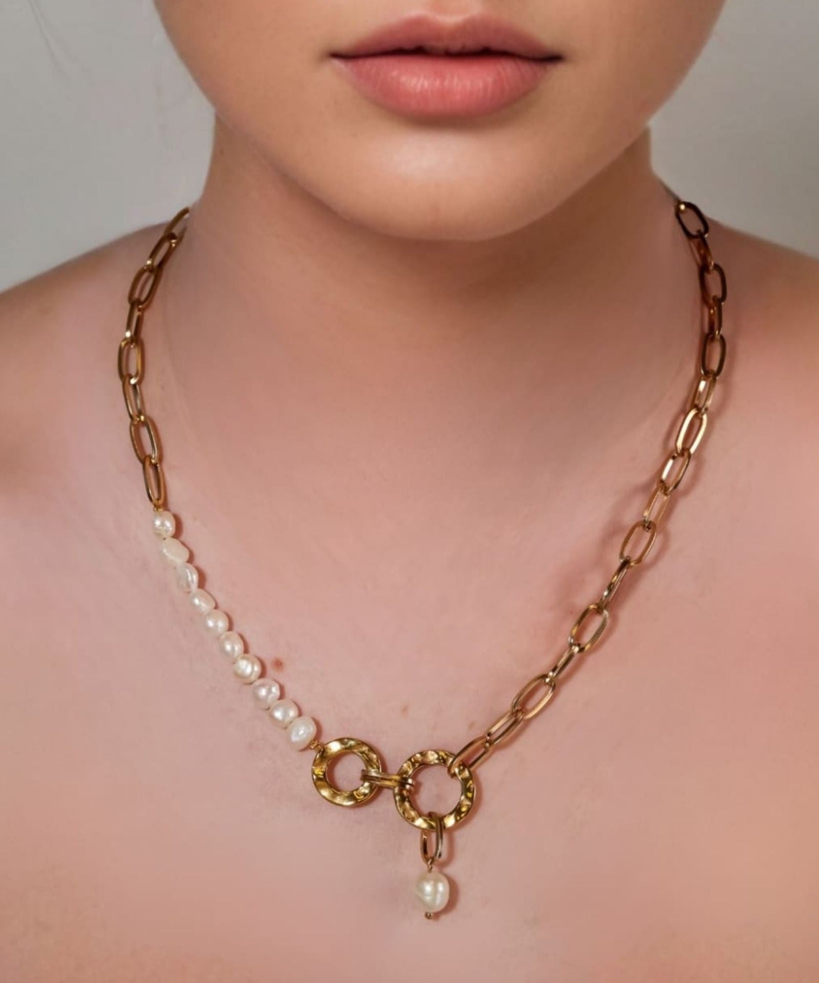 Sardinia Gold Pearl Necklace by Lavana on model with asymmetric links and freshwater pearl drop