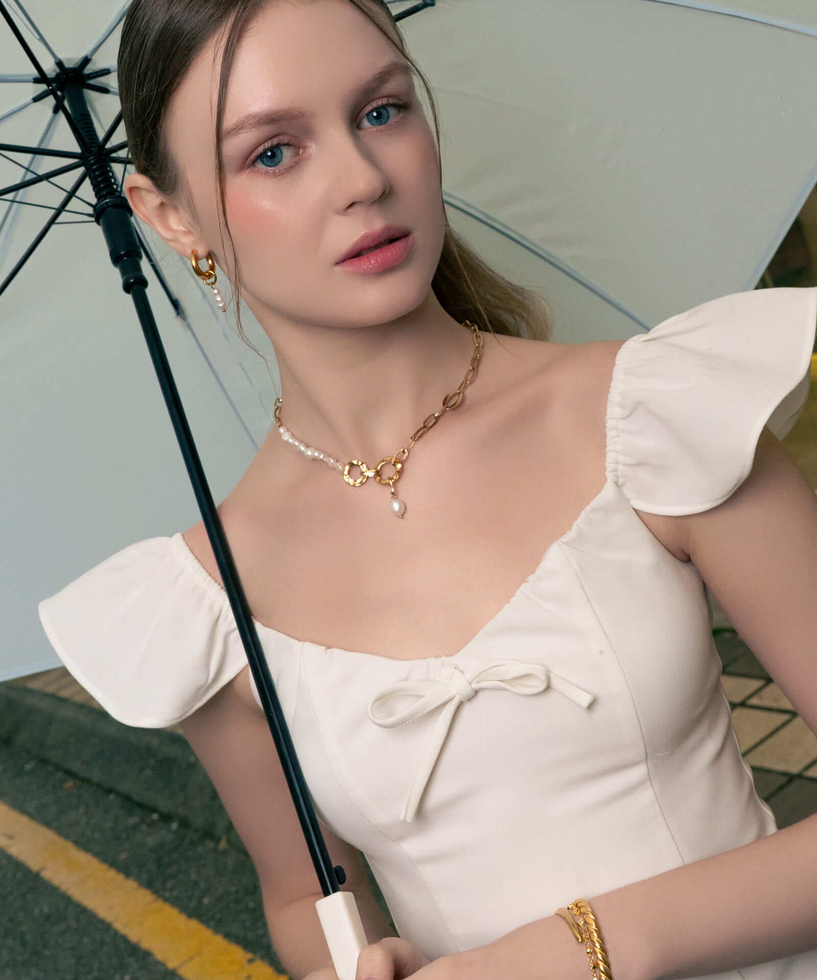 Sardinia gold pearl necklace by Lavana, on model; with classic asymmetric links and freshwater pearl drop