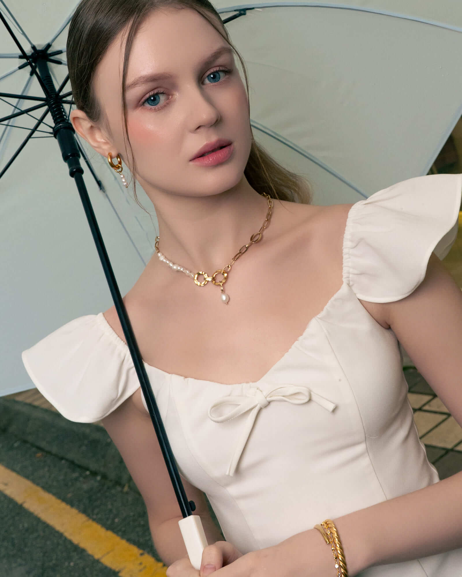 Sardinia gold pearl necklace by Lavana, on model; with classic asymmetric links and freshwater pearl drop