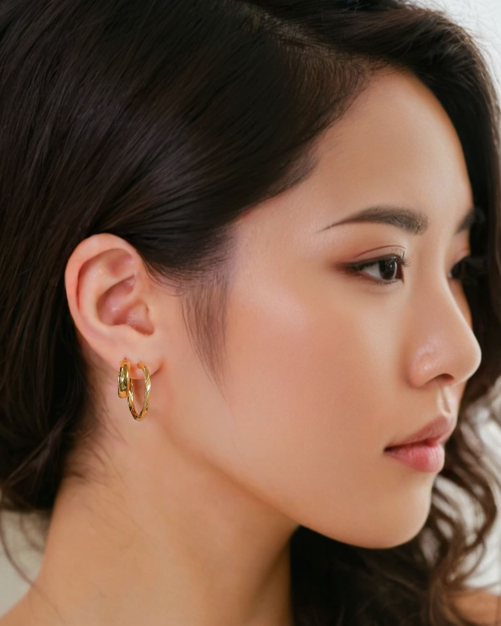 Sculptural Gold Hoop Earrings by Lavana on model round hoops with soft sculptural twist large