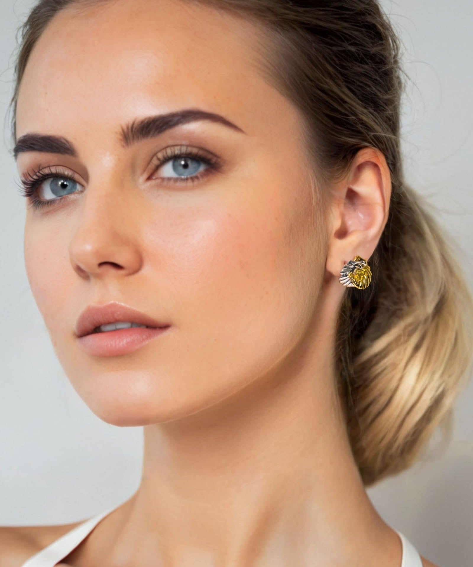 Seashell Two Tone Stud Earrings by Lavana on model silver outer shell with gold inner detail