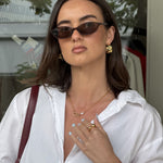 Sirocco Gold chunky hoop earrings by LAVANA on model with fluid sculptural texture