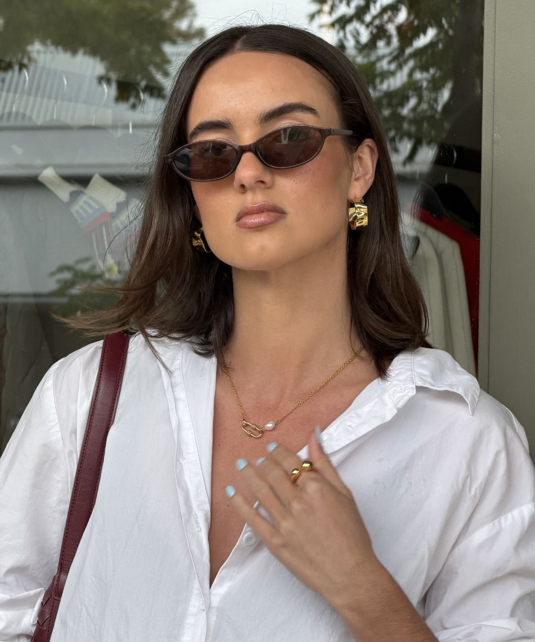 Sirocco Gold chunky hoop earrings by LAVANA on model with fluid sculptural texture