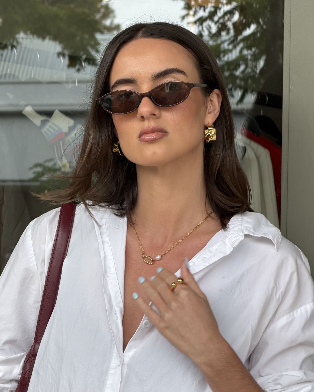 Sirocco Gold chunky hoop earrings by LAVANA on model with fluid sculptural texture