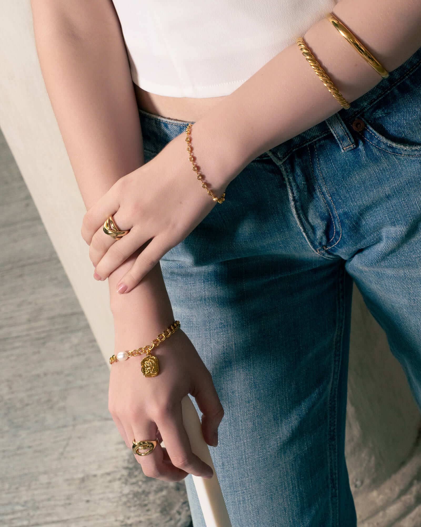 Sorrento Gold Pearl Bracelet by Lavana, on model; modern chunky link chain with pearl and medallion charm